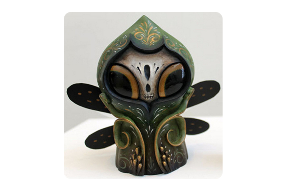 Seemingly winged figure that appears to be wearing a hooded cloak, dark colors black green and gold